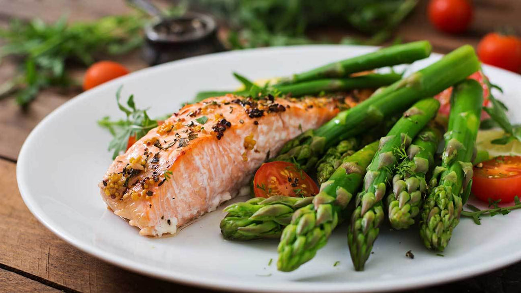 A plate of salmon and asparagus; both low carb foods.